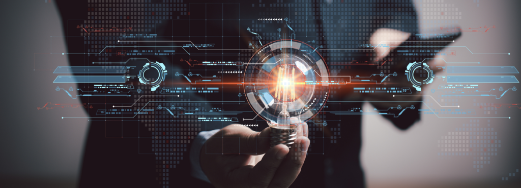 A person in a suit holding a glowing light bulb with digital futuristic interface graphics overlayed, including circuit-like lines and circular HUD elements, against a blurred background.