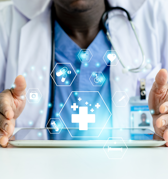 A doctor wearing a white coat and blue scrubs is holding a tablet with holographic medical icons floating above it. The icons include a medical cross, pills, a heart, a wheelchair symbol, a syringe, a test tube, a hospital bed, and a medical report, all glowing with a blue light. The doctor has a stethoscope around their neck and an ID badge clipped to their coat.